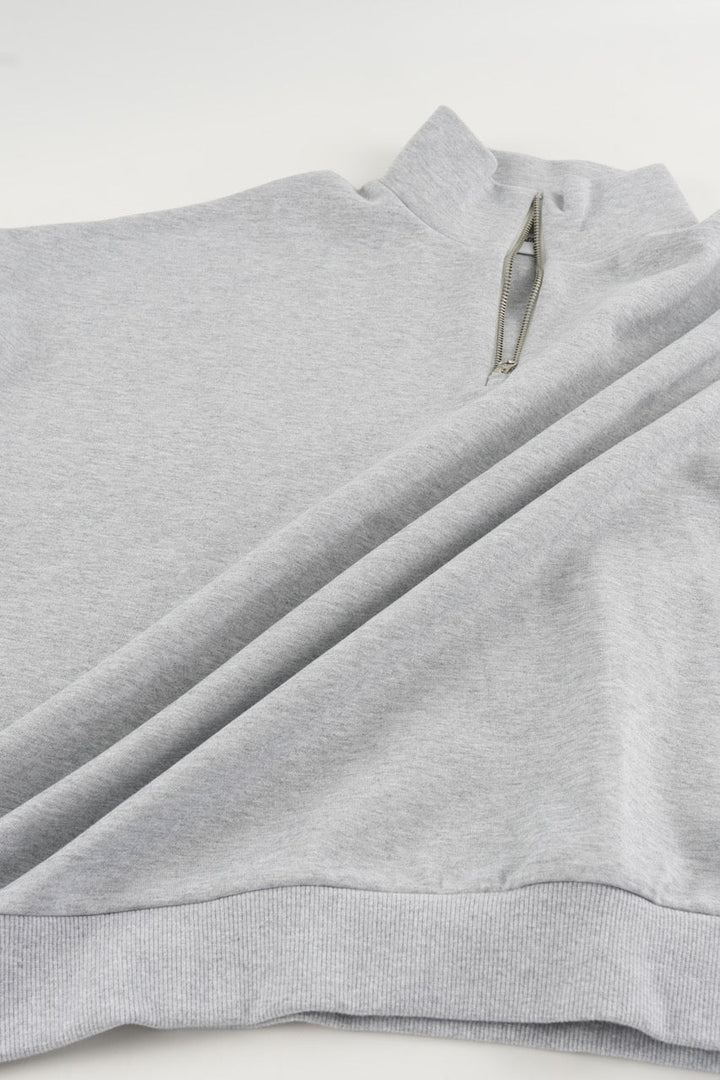 Gray cropped quarter-zip hoodie with mock neck and long sleeves