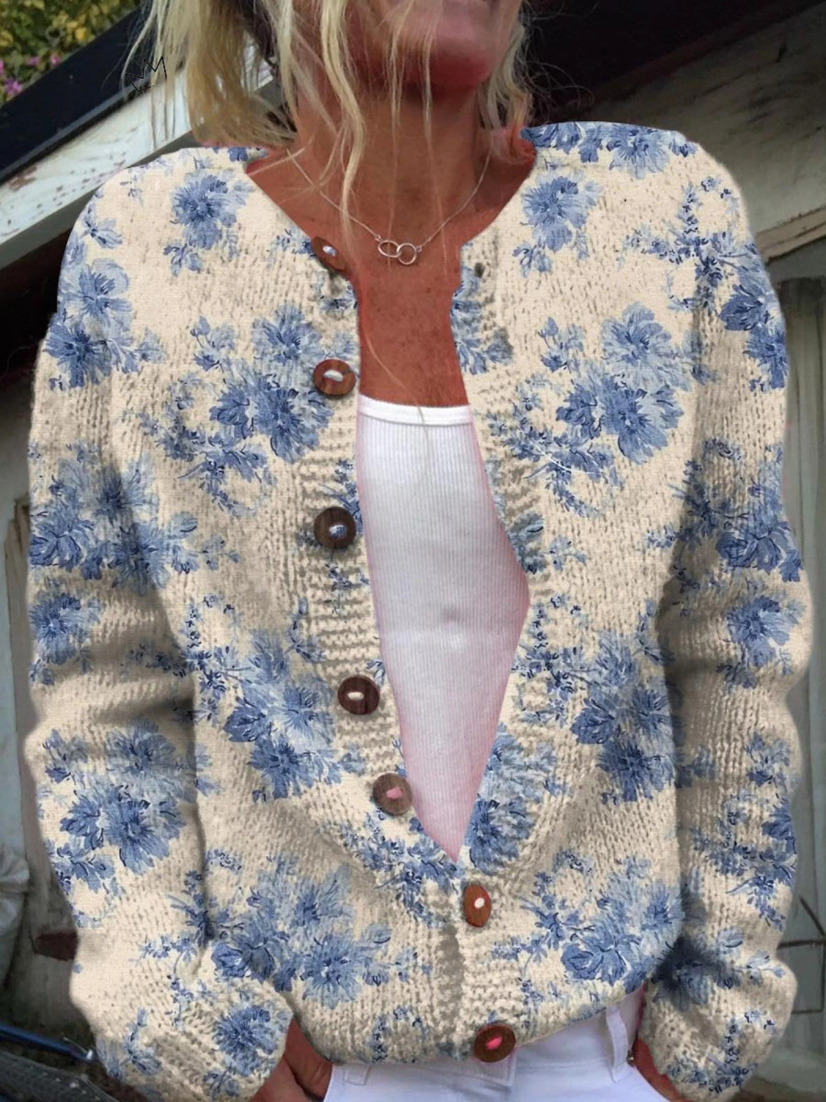 Women's beige cardigan with blue floral pattern and brown buttons