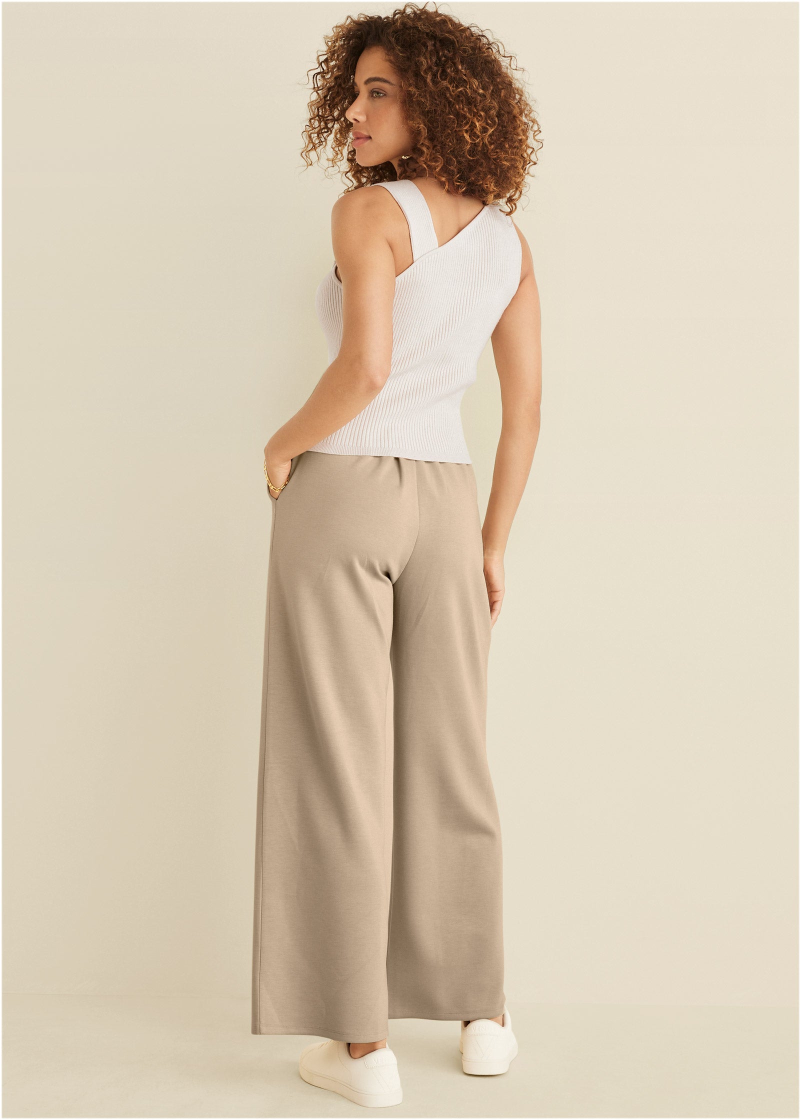 Women's white ribbed sweater tank top with asymmetric twist neckline