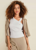 Women's white ribbed sweater tank top with asymmetric twist neckline