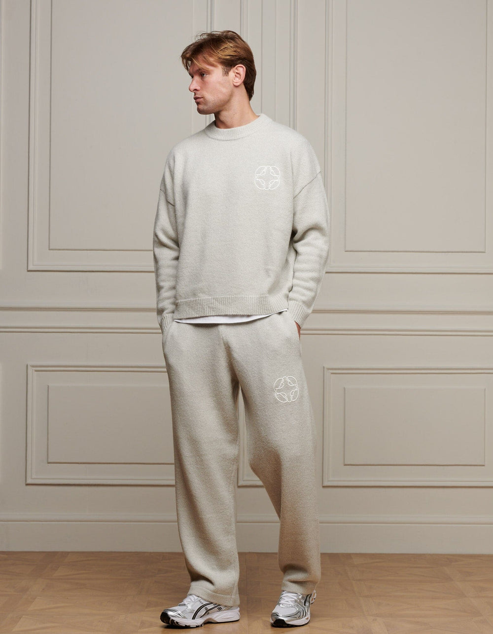 Men's grey marl knit jumper with crew neck, long sleeves and chest emblem