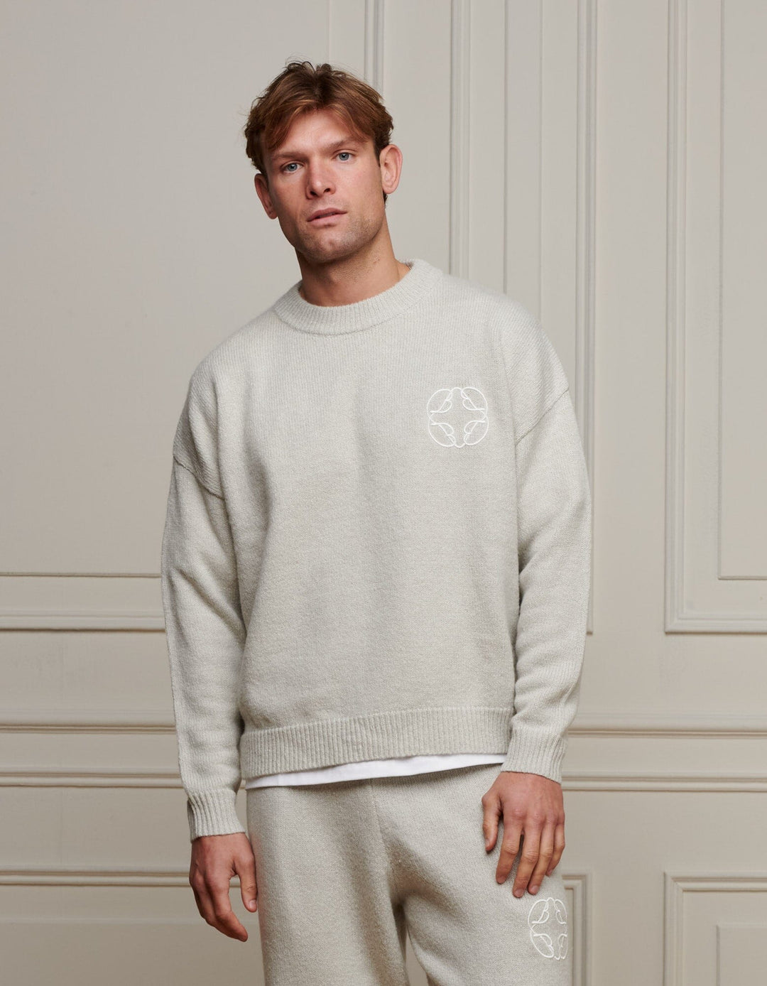 Men's grey marl knit jumper with crew neck, long sleeves and chest emblem
