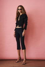 Women's black cropped knit cardigan with buttons and long sleeves