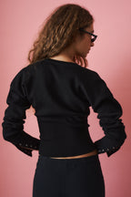 Women's black cropped knit cardigan with buttons and long sleeves