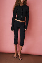 Women's black cropped knit cardigan with buttons and long sleeves