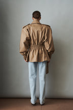Women's khaki belted trench jacket with wide lapels and flap pockets