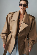 Women's khaki belted trench jacket with wide lapels and flap pockets