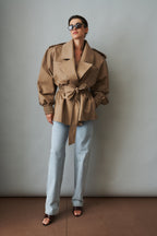 Women's khaki belted trench jacket with wide lapels and flap pockets
