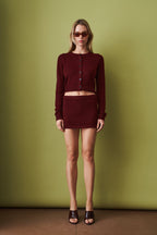 Women's red cropped knit cardigan with round neck and button front
