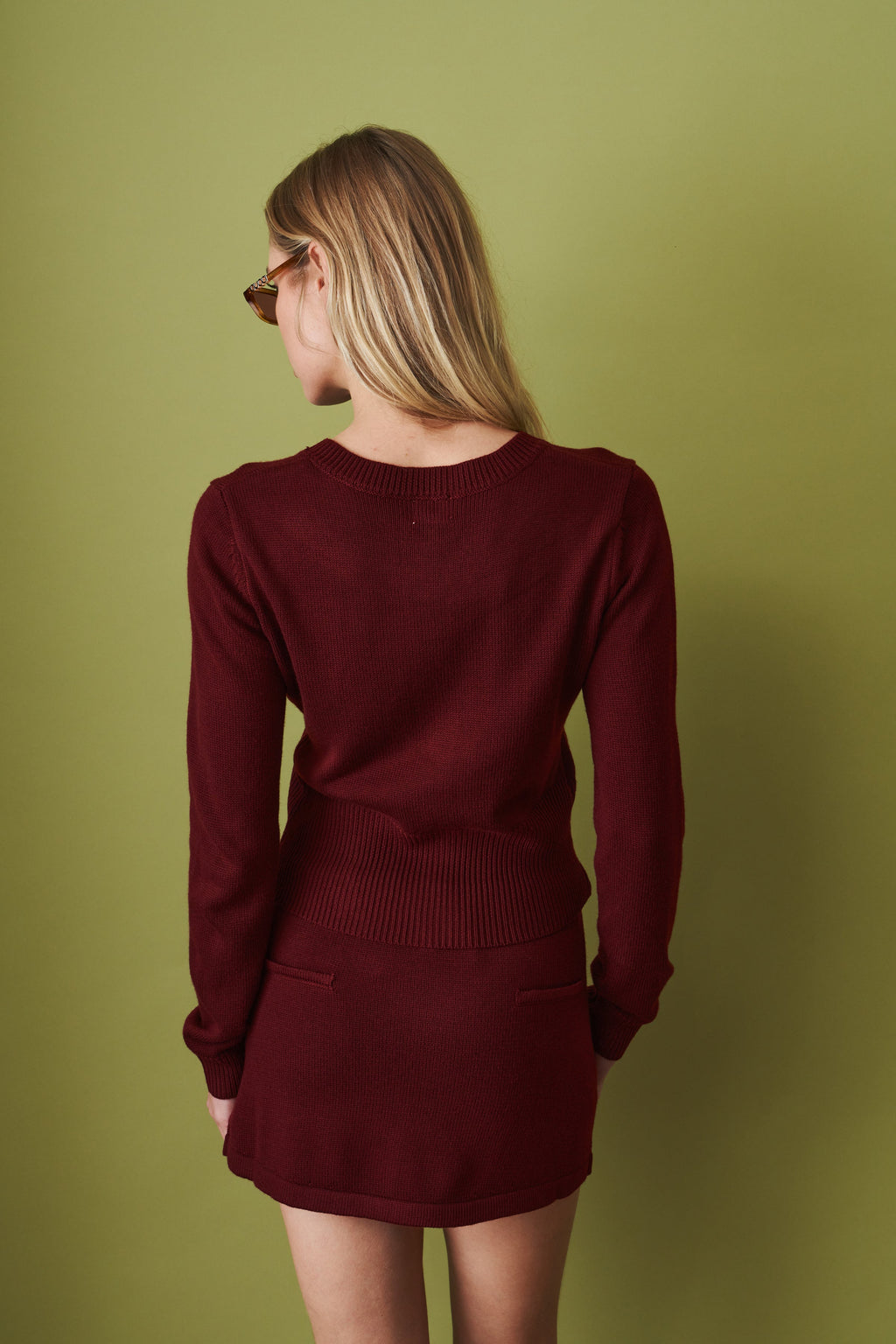 Women's red cropped knit cardigan with round neck and button front