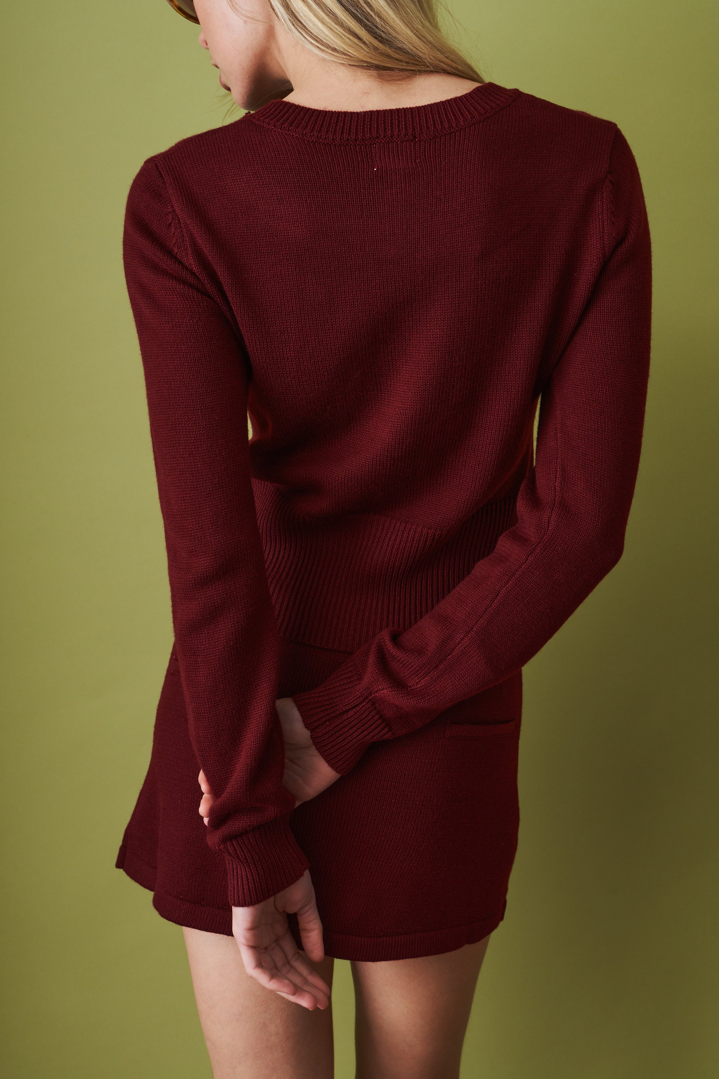 Women's red cropped knit cardigan with round neck and button front
