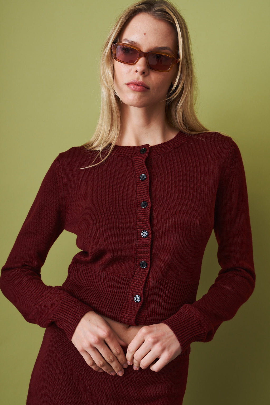 Women's red cropped knit cardigan with round neck and button front