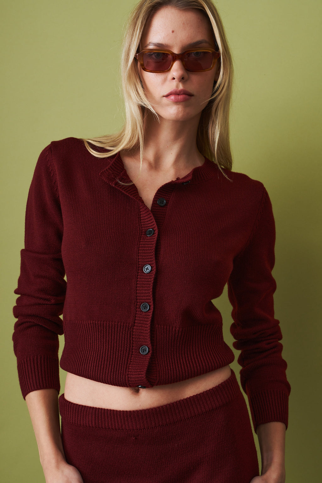 Women's red cropped knit cardigan with round neck and button front
