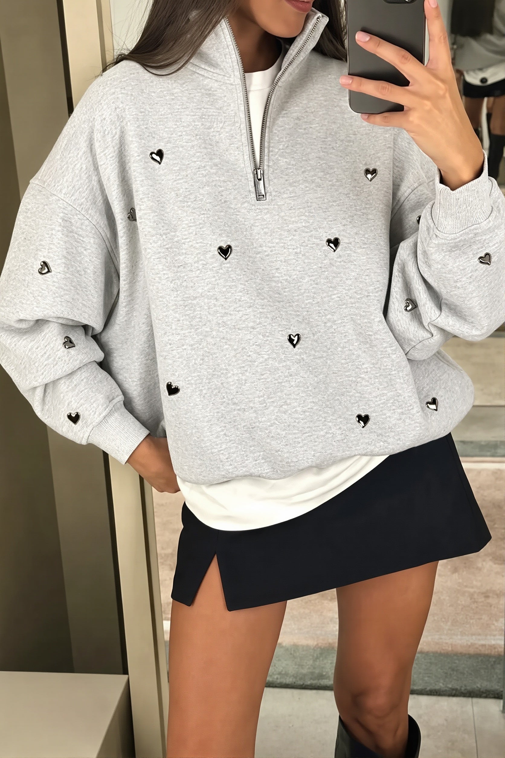 Women's light gray half-zip sweatshirt with black heart studs