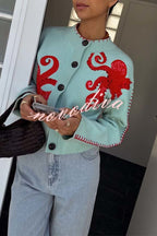 Women's pale blue cardigan with red octopus graphics and button front