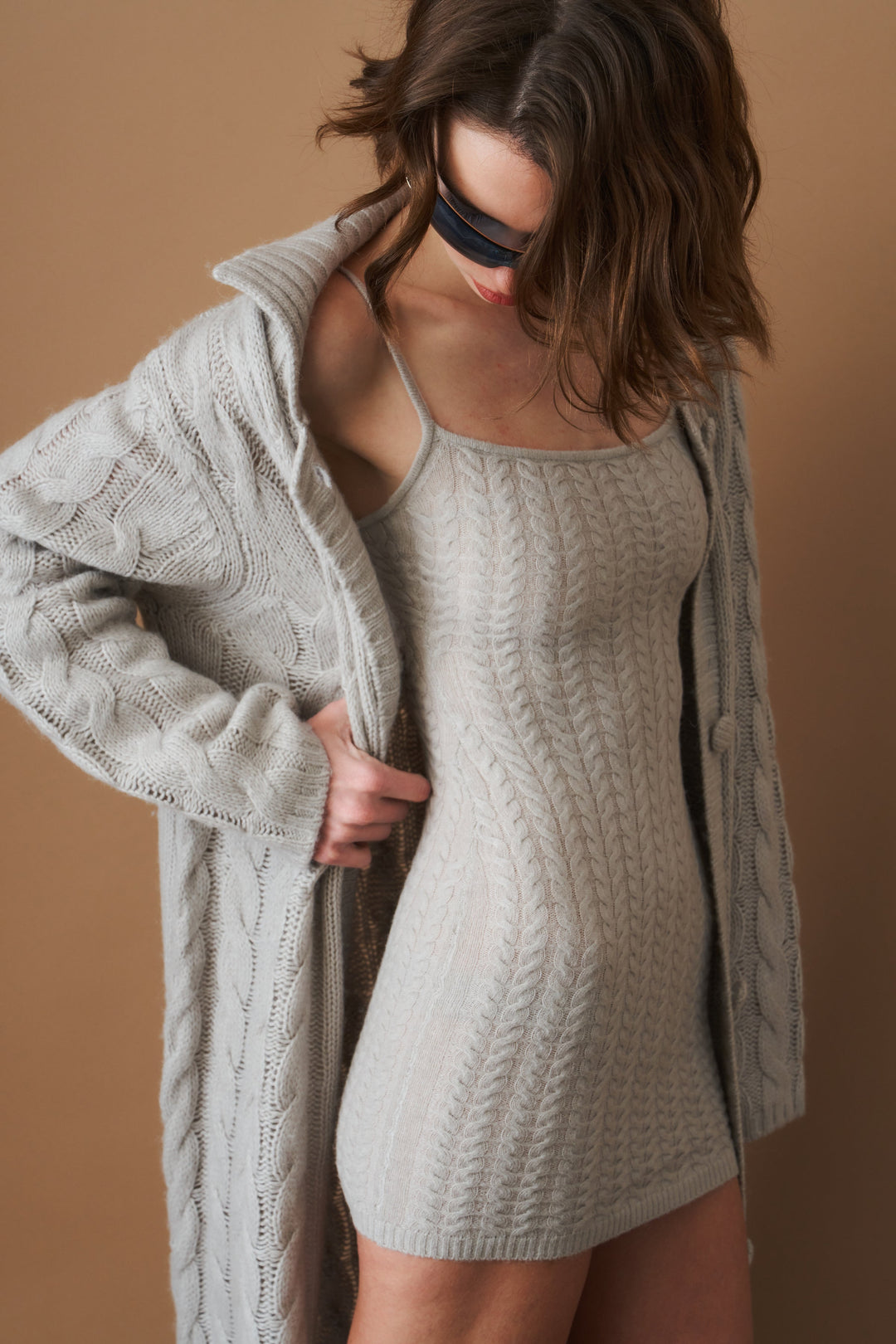 Women's light grey long cable knit cardigan with buttons and wide collar