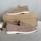 Men's slip-on loafers with textured uppers, moc toe stitching and white flat soles
