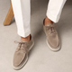 Men's lace-up moccasin shoes shown in black and beige with round toes and flat soles