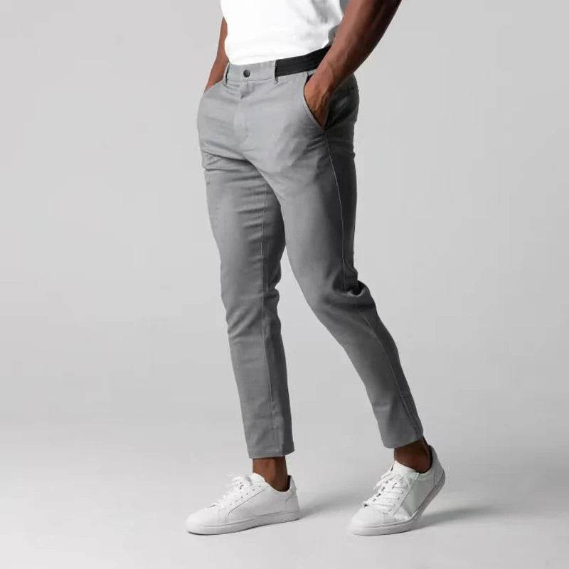 Men's slim tapered chinos trousers shown in black and navy with side pockets