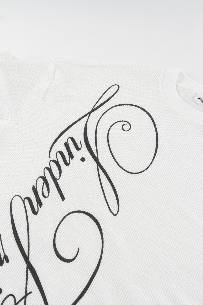 White waffle sweatshirt with black script graphic and long sleeves