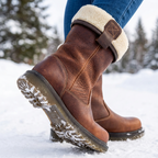 Brown fur-lined ankle boots with cream cuffs and buckle details