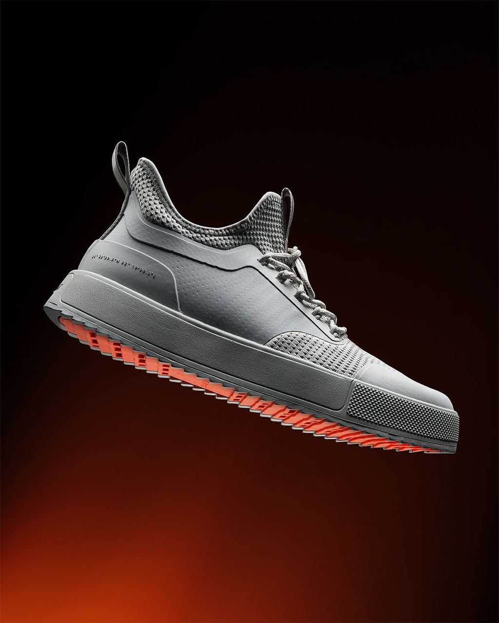 Grey low-top lace-up sneakers with mesh panels and flat sole