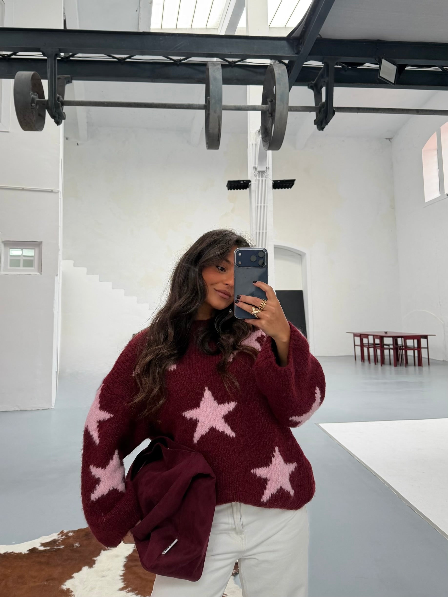 Women's burgundy sweater with contrasting pink star pattern and long sleeves