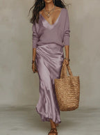 Women's midi slip dress layered with a long-sleeve V-neck sweater
