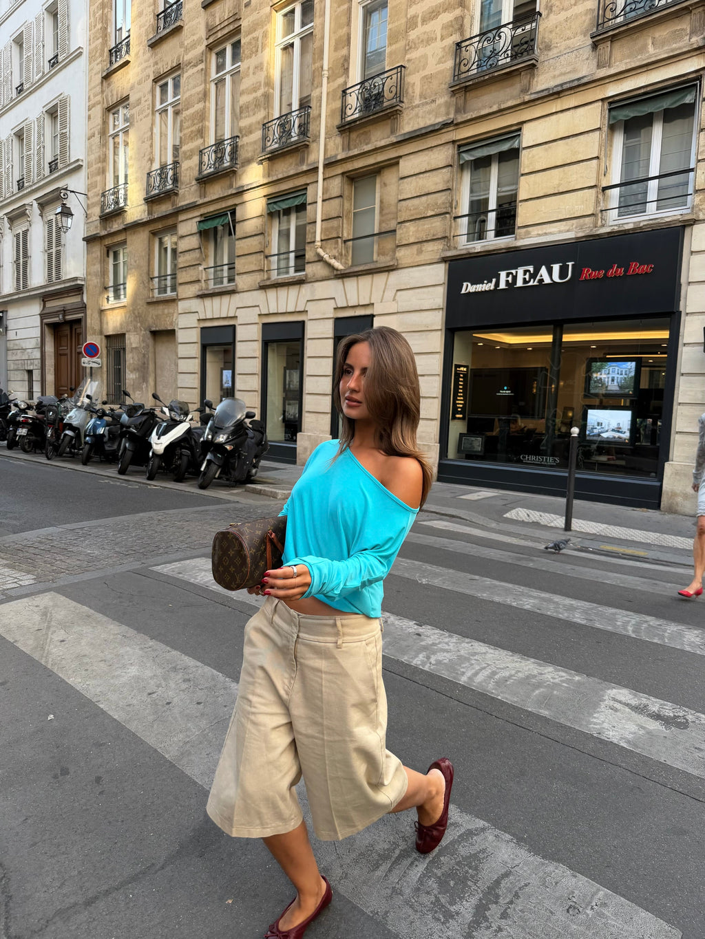 Women's blue asymmetric long sleeve top worn off one shoulder