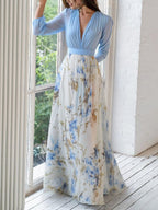 Women's floral maxi dress with blue long sleeves and flowing printed skirt