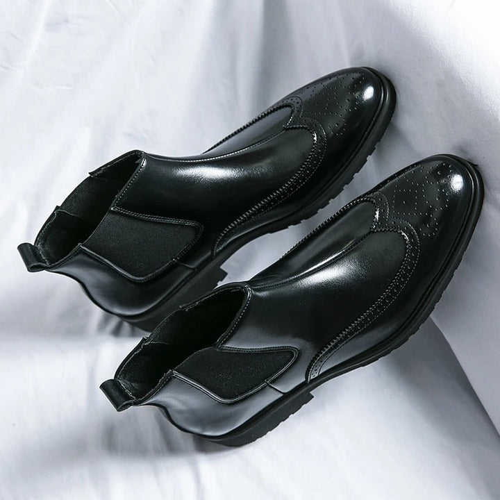 Chelsea boots with brogue toe detailing, elastic side panels and lugged soles
