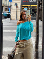 Women's blue asymmetric long sleeve top worn off one shoulder