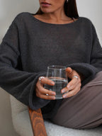 Women's open-knit oversized sweater with wide sleeves and crew neck
