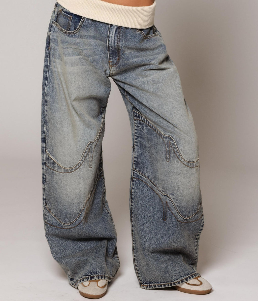 Women's washed blue wide-leg jeans with contrasting curved panel detailing