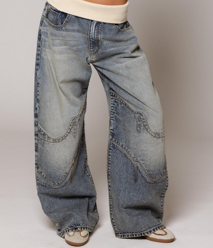 Women's washed blue wide-leg jeans with contrasting curved panel detailing