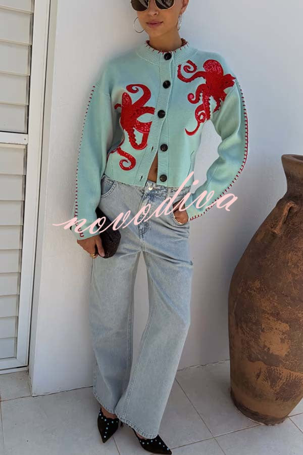 Women's pale blue cardigan with red octopus graphics and button front