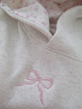 Women's light grey oversized hoodie with pink bow embroidery and floral-lined hood
