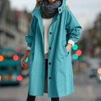 Women's longline hooded rain coat with button front and side pockets