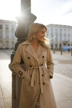 Women's long belted double-breasted trench coat with wide collar and cuff straps