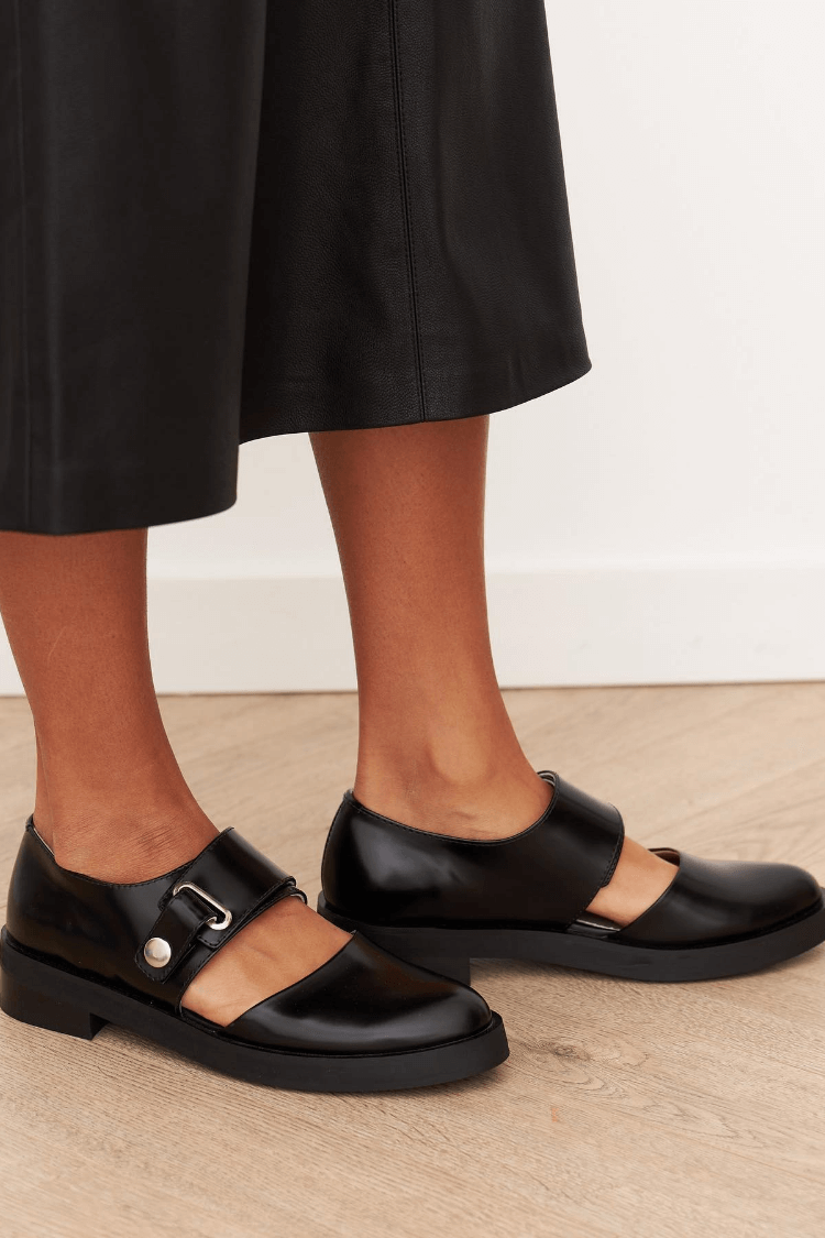 Women's black loafers with buckle straps and round toes