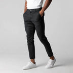 Men's slim tapered chinos trousers shown in black and navy with side pockets