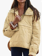 Women's oversized hooded quilted pullover jacket with long sleeves and front pockets