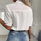 White women's blouse with floral embroidery and short sleeves
