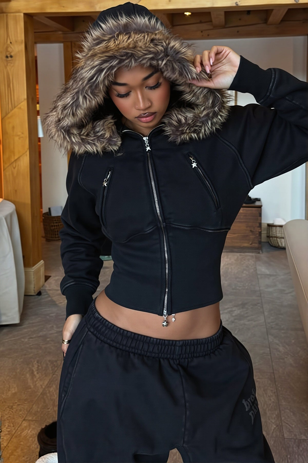 Women's black cropped zip hoodie with faux fur trimmed hood and zipped pockets