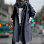 Women's longline hooded rain coat with button front and side pockets
