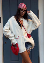 Women's oversized cable knit cardigan with buttons and embroidered motifs