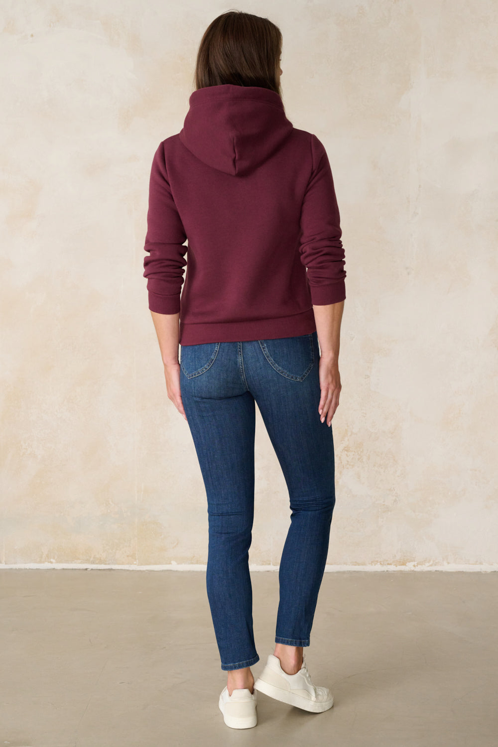 Women's blue slim fit jeans with mid-rise waist and ankle-length legs
