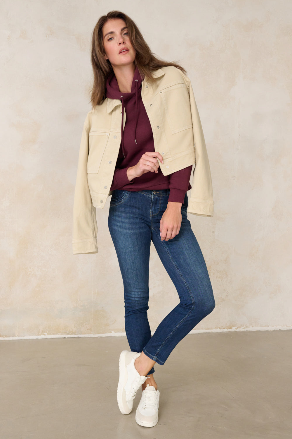 Women's blue slim fit jeans with mid-rise waist and ankle-length legs
