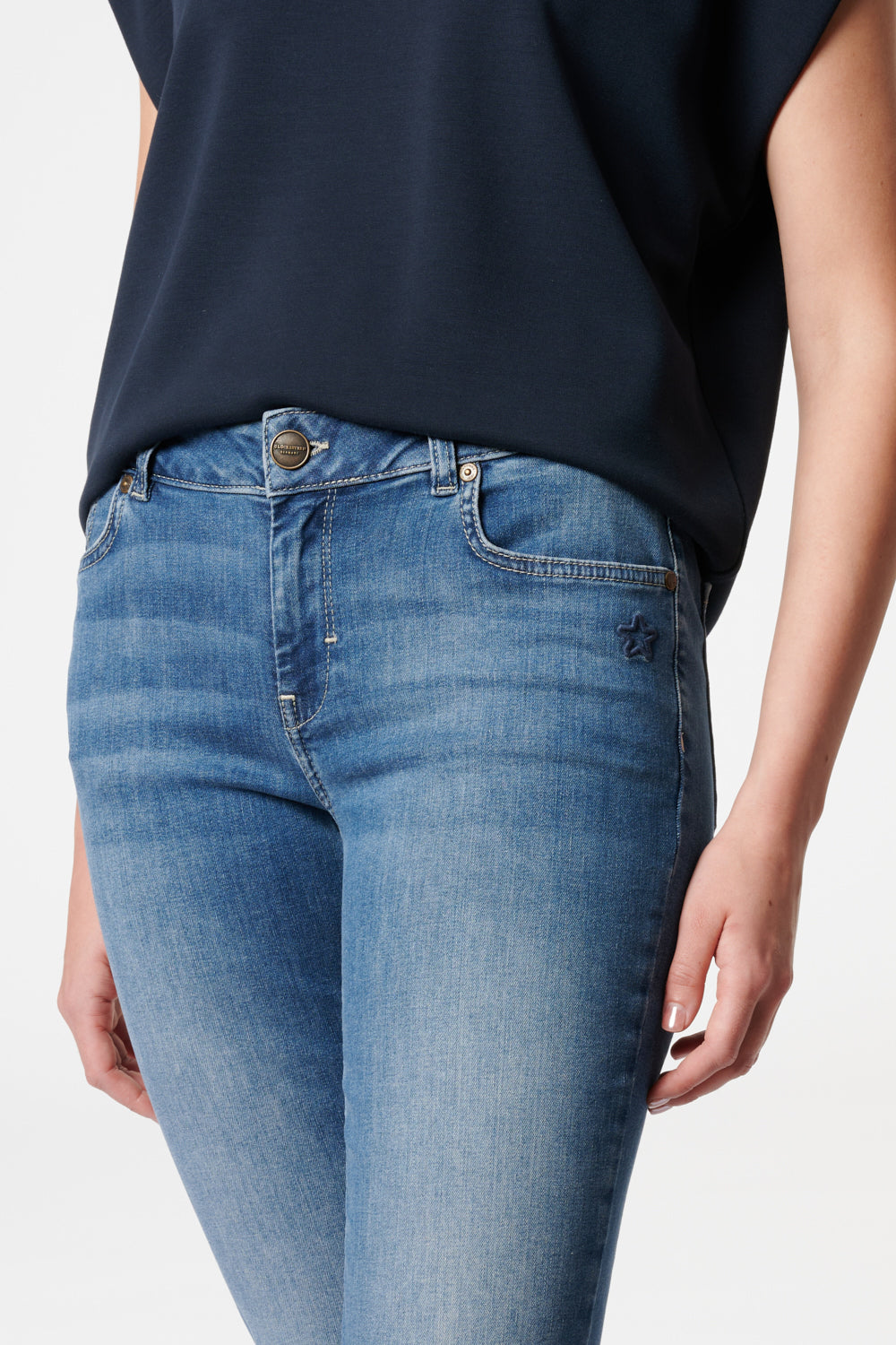 Women's blue bootcut jeans with mid-rise waist