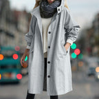 Women's longline hooded rain coat with button front and side pockets
